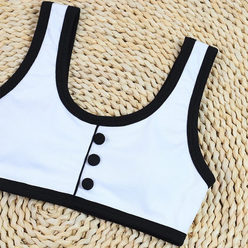 Maillot de bain deux pièces femme, élégant, blanc avec bordure noire et boutons décoratifs.