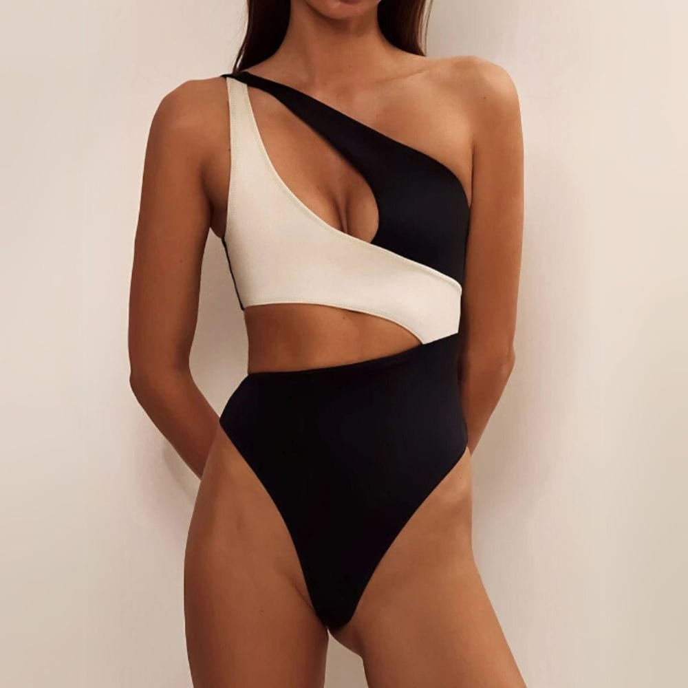 Maillot de bain une pièce asymétrique noir et blanc pour femme, style élégant et moderne.