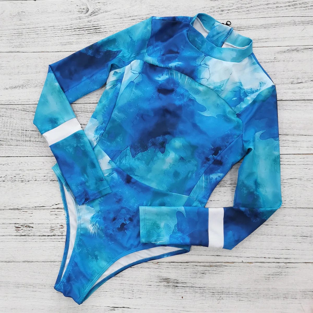 Maillot de bain une pièce bleu motif aquarelle à manches longues pour femmes, élégant et moderne.