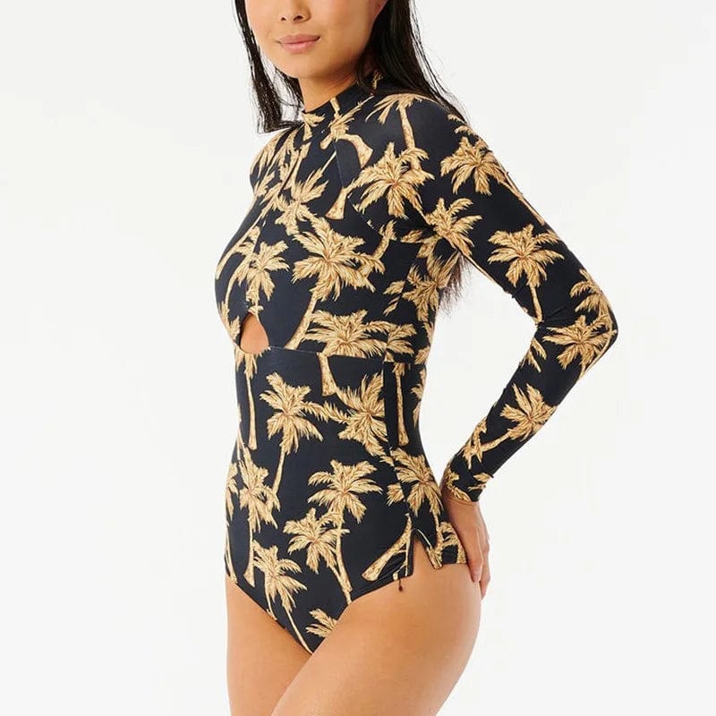 Maillot de bain une pièce femme à manches longues imprimé tropical élégant et moderne.