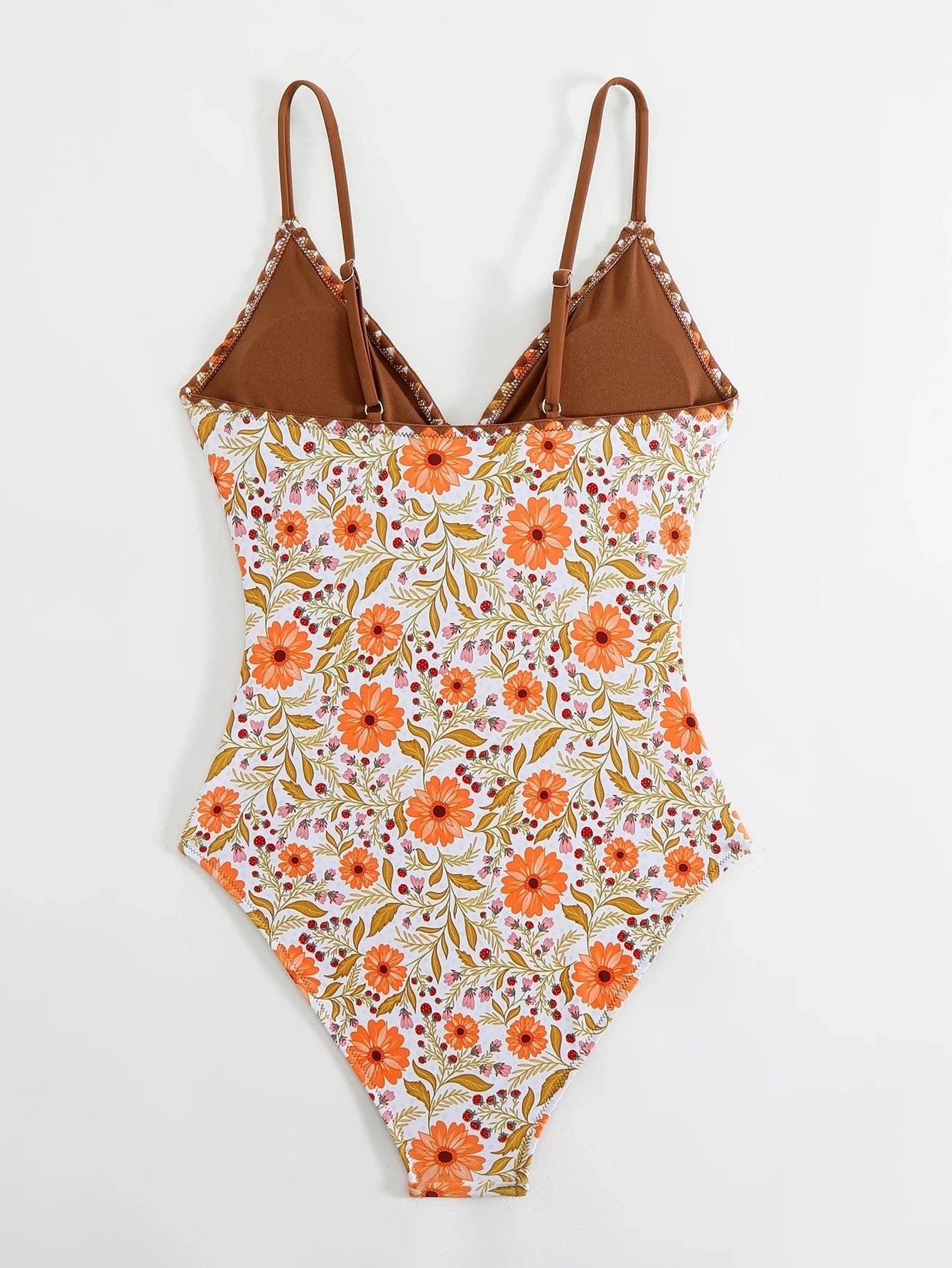 Maillot de bain une pièce pour femme, motif fleuri orange et marron sur fond blanc élégant.