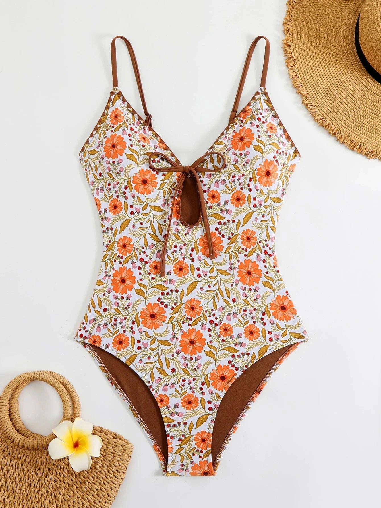 Maillot de bain 1 pièce fleuri, dos nu à motif floral orange et blanc, élégant pour l'été.
