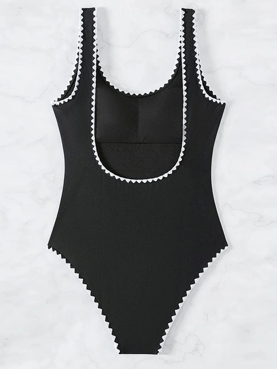 Maillot de bain une pièce noir avec bordures blanches pour femme, élégant et moderne.