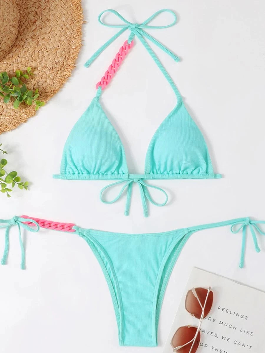 Maillot de bain bikini femme bleu clair, détails rose, style échancré et nœuds ajustables.