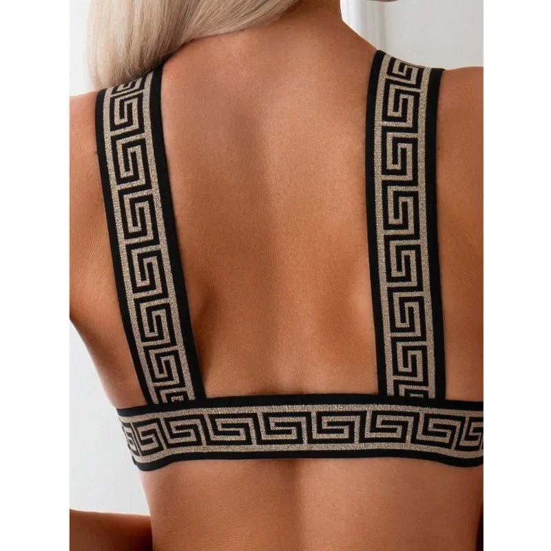 Maillot de bain femme noir deux pièces avec motifs géométriques élégants sur les bretelles.