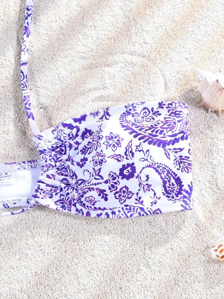 Maillot de bain femme avec motif floral violet sur le sable, style bandeau, paréo en option.